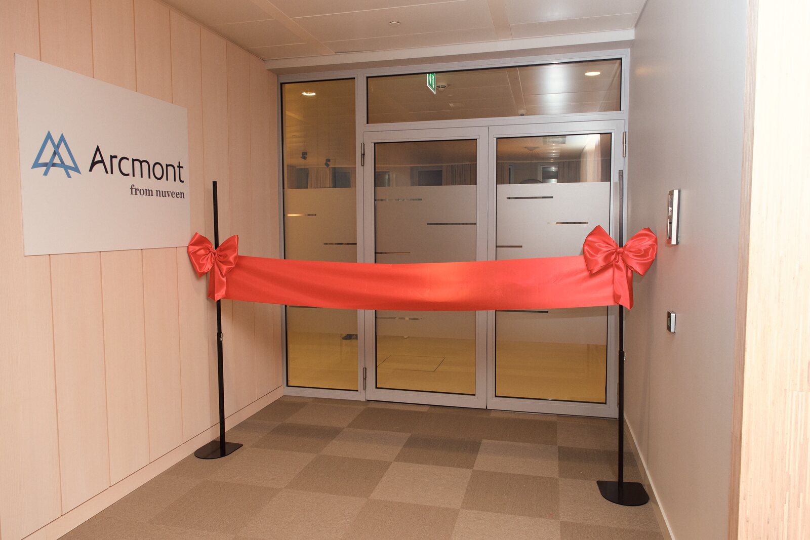 Arcmont — Arcmont-Logo und rotes Band am Büroeingang