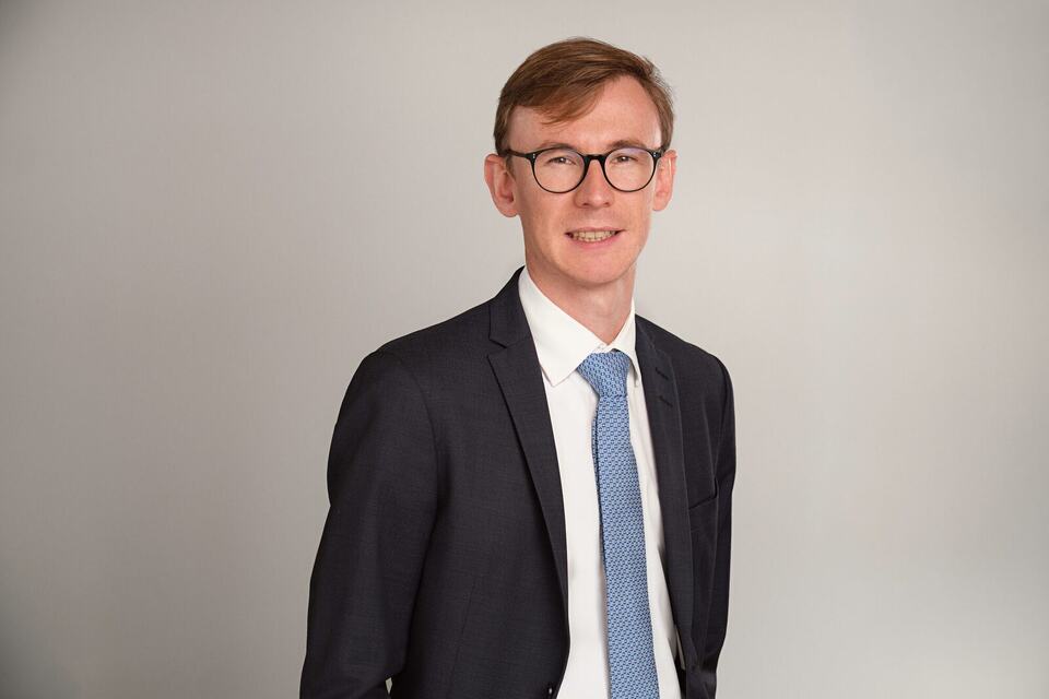 Suit and tie on light grey